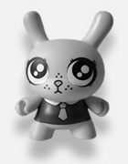 A plastic toy bunny with dopey eyes and freckles, wearing a shirt and a tie.